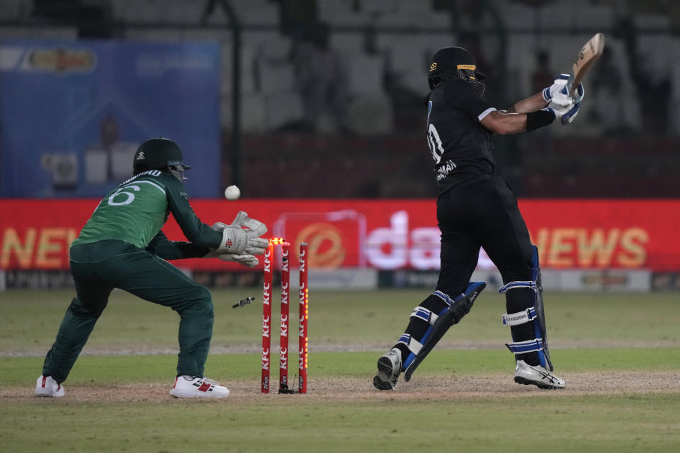 New Zealand's Mark Chapman, right, is bowled out by Pakistan's Usama Mir during the fourth one-day international cricket match between Pakistan and New Zealand, in Karachi, Pakistan, Friday, May 5, 2023. (AP Photo/Fareed Khan)