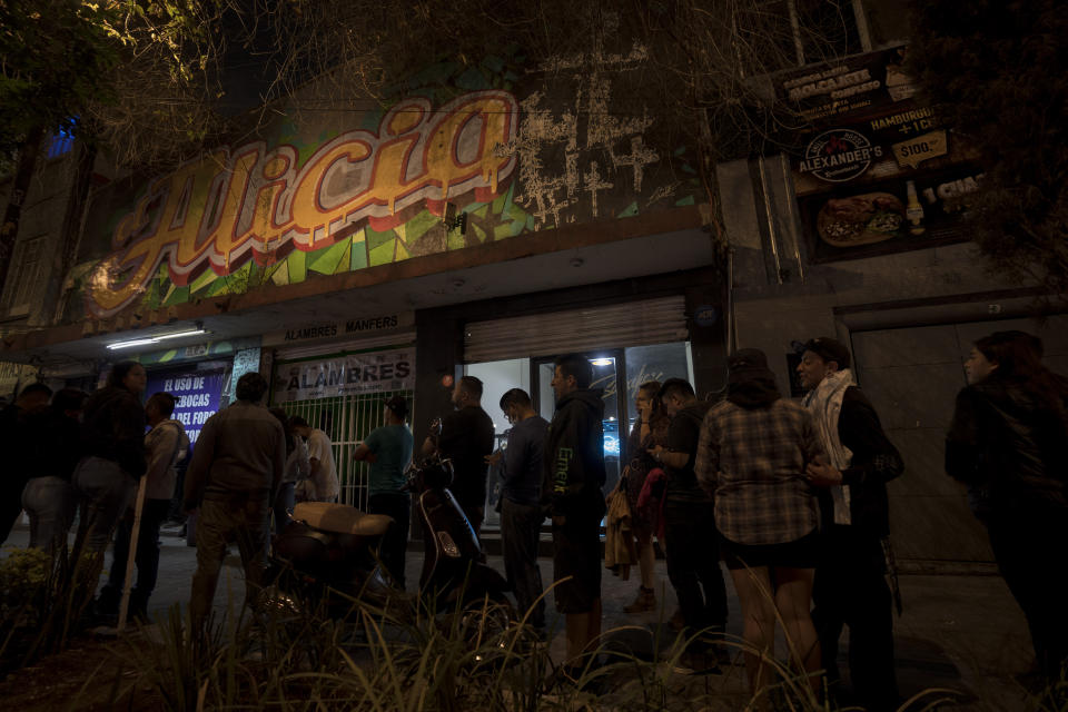 Fans of the Mexican Ska band Nana Pancha wait outside during one of the last active weekends at the iconic counterculture venue Multiforo Alicia in Mexico City, Friday, Feb. 10, 2023. As the venue closes its doors forever, the same neighbors who once looked down on the space, now wander by and tell the owner and founder of Alicia Ignacio Pineda they will miss him and the Alicia. (AP Photo/Eduardo Verdugo)