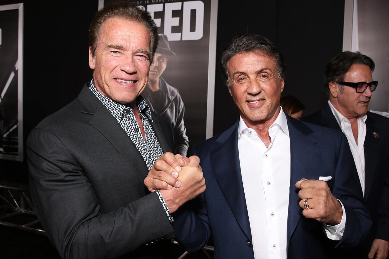 Arnold Schwarzenegger (L) and Producer Sylvester Stallone attend the premiere of Warner Bros. Pictures' "Creed" at Regency Village Theatre on November 19, 2015 in Westwood, California.