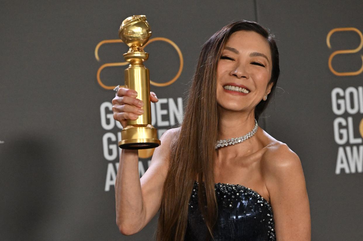 Malaysian actress Michelle Yeoh poses with the award for Best Actress - Motion Picture - Musical/Comedy for 