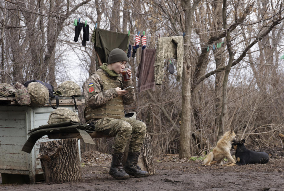 A Ukrainian female soldier take a rest near a fighting position on the line of separation from pro-Russian rebels near Debaltsevo, Donetsk region, Ukraine, Ukraine Friday, Dec 3, 2021. In this Friday, the Ukrainian defense minister warned that Russia could invade his country next month. Russia-West tensions escalated recently with Ukraine and its Western backers becoming increasingly concerned that a Russian troop buildup near the Ukrainian border could signal Moscow's intention to invade. (AP Photo/Andriy Dubchak)