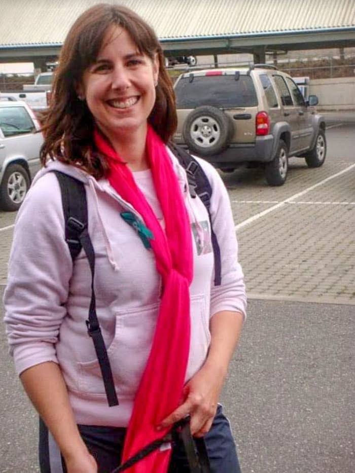 The author learned the symptoms of ovarian cancer a decade before her own diagnosis. In this 2010 photo taken at a Cancer Walk, she's wearing pink for breast cancer awareness and a small teal ribbon signifying ovarian cancer