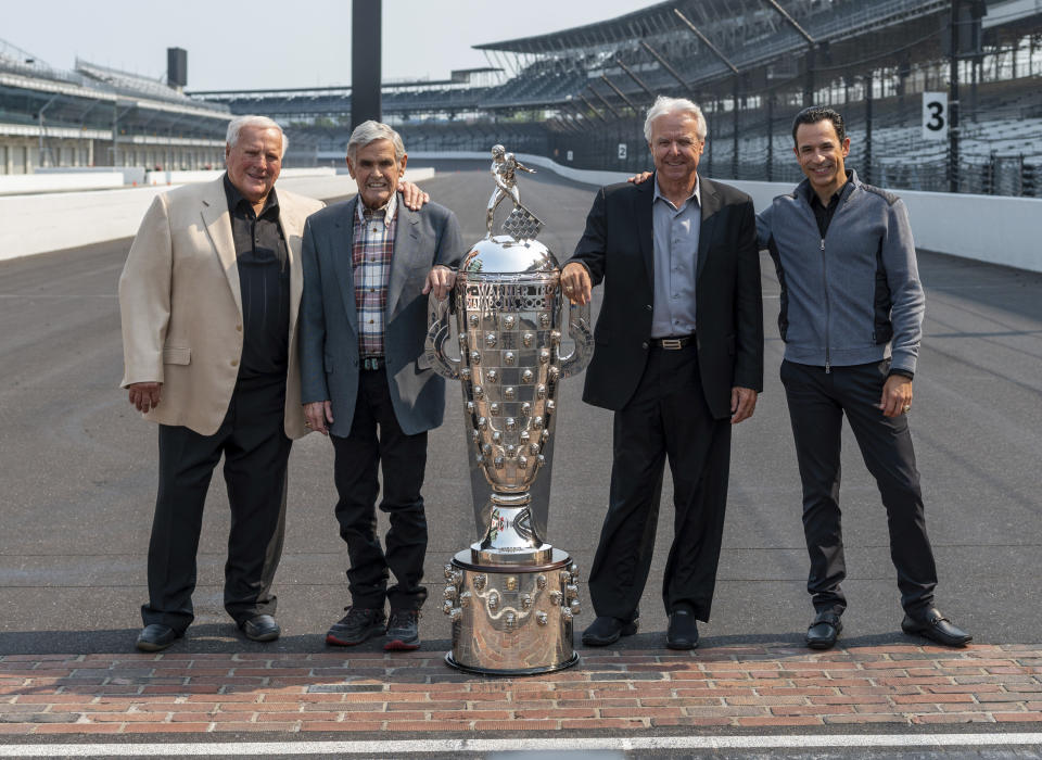 Winner of this year's Indianapolis 500 auto race, Helio Castroneves, right, gathered with other four-time winners, from left, A.J. Foyt (1961, 1964, 1967, 1977), Al Unser (1970, 1971, 1978, 1987) and Rick Mears (1979, 1984, 1988, 1991) at the Indianapolis Motor Speedway in Indianapolis, Tuesday, July 20, 2021. Castroneves won the race in 2001, 2002, 2009 and 2021. (AP Photo/Doug McSchooler)