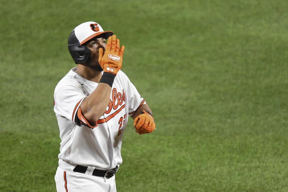 Baltimore Orioles' Anthony Santander gestures towards the sky after hitting a two-run home run which scored Baltimore Orioles' Trey Mancini against Los Angeles Angels relief pitcher Andrew Wantz during the sixth inning of a baseball game Tuesday, Aug. 24, 2021, in Baltimore. (AP Photo/Terrance Williams)