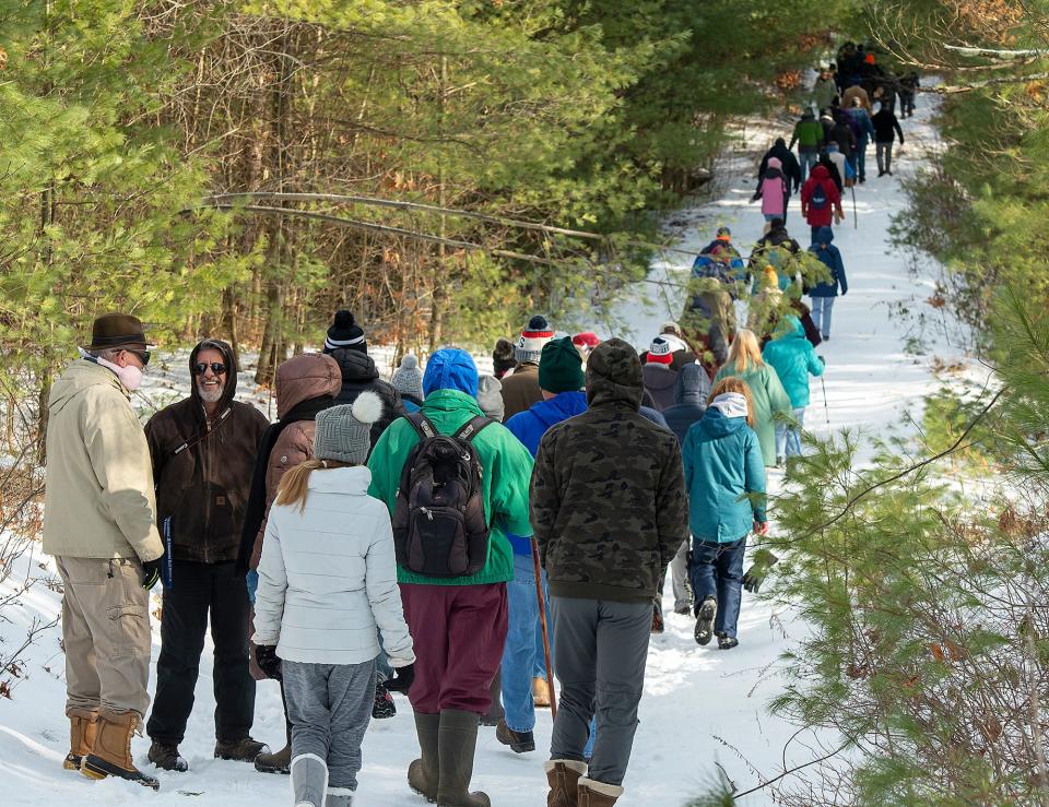 Rangers lead about 100 people to a spot on the Wachusett Reservoir during the annual First Day Hike on Jan. 1, 2020 in Massachusetts.