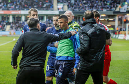 Malmo FF soccer player Tobias Sana (C) reacts after being hit by a large firecracker from the stands during the IFK Goteborg vs. Malmo FF match in Goteborg, Sweden April 27, 2016. An assistant referee was injured by the blast and the match was called off. TT News Agency/Adam Ihse/via REUTERS