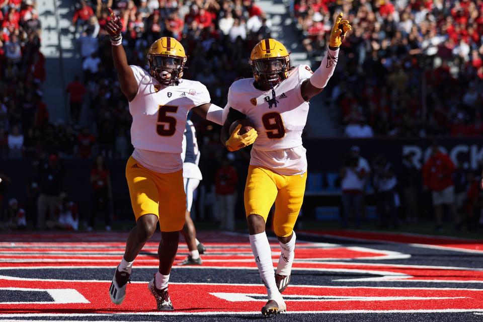 Defensive back Ro Torrence #9 of the Arizona State Sun Devils celebrates with Chris Edmonds #5 after Torrence intercepted a pass from the Arizona Wildcats during the first half of the NCAAF game at Arizona Stadium on Nov. 25, 2022, in Tucson, Arizona. This year's game is the 96th annual Territorial Cup match between Arizona's rival schools.