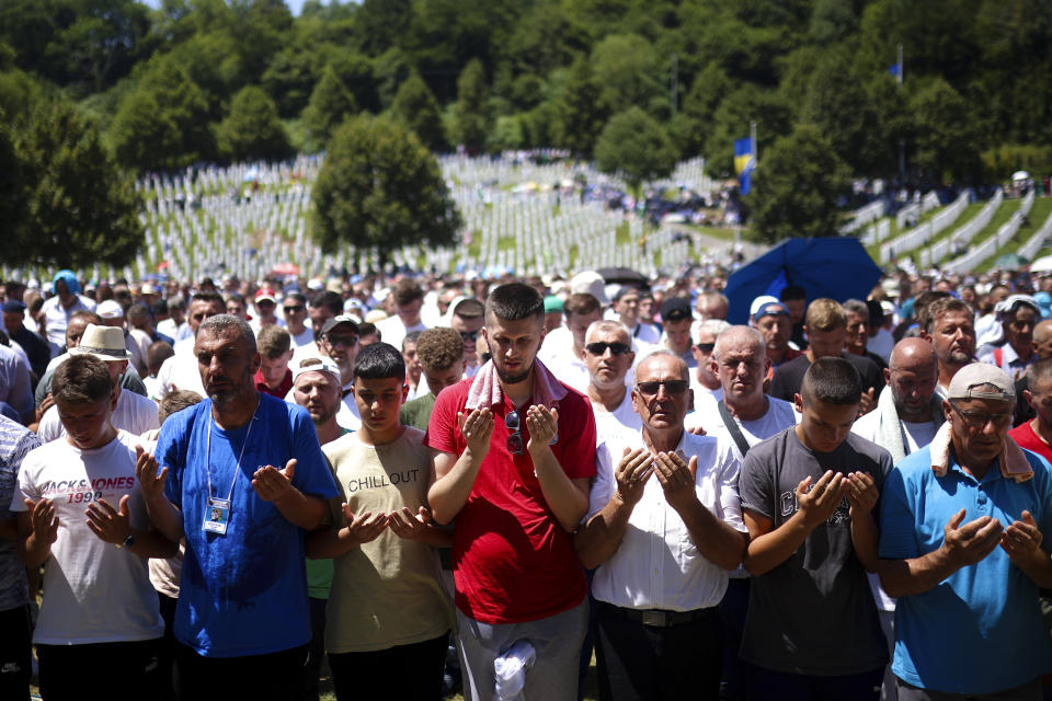 Bosnian muslim man pray during the mass burial ceremony for the 14 newly identified victims of the Srebrenica genocide, at the Srebrenica Memorial Centre, in Potocari, Bosnia, Thursday, July 11, 2024. Thousands gather in the eastern Bosnian town of Srebrenica to commemorate the 29th anniversary on Monday of Europe's only acknowledged genocide since World War II. (AP Photo/Armin Durgut)