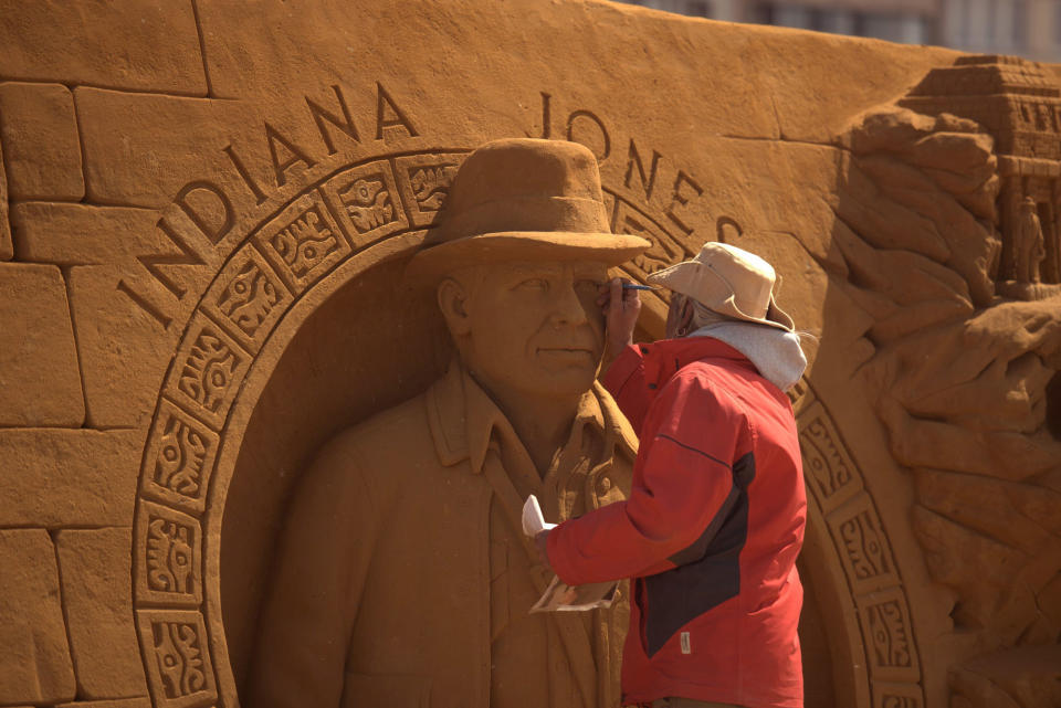 <p>A sand carver works on a sculpture during the Sand Sculpture Festival “Disney Sand Magic” in Ostend, Belgium. (Photo courtesy of Disneyland Paris) </p>