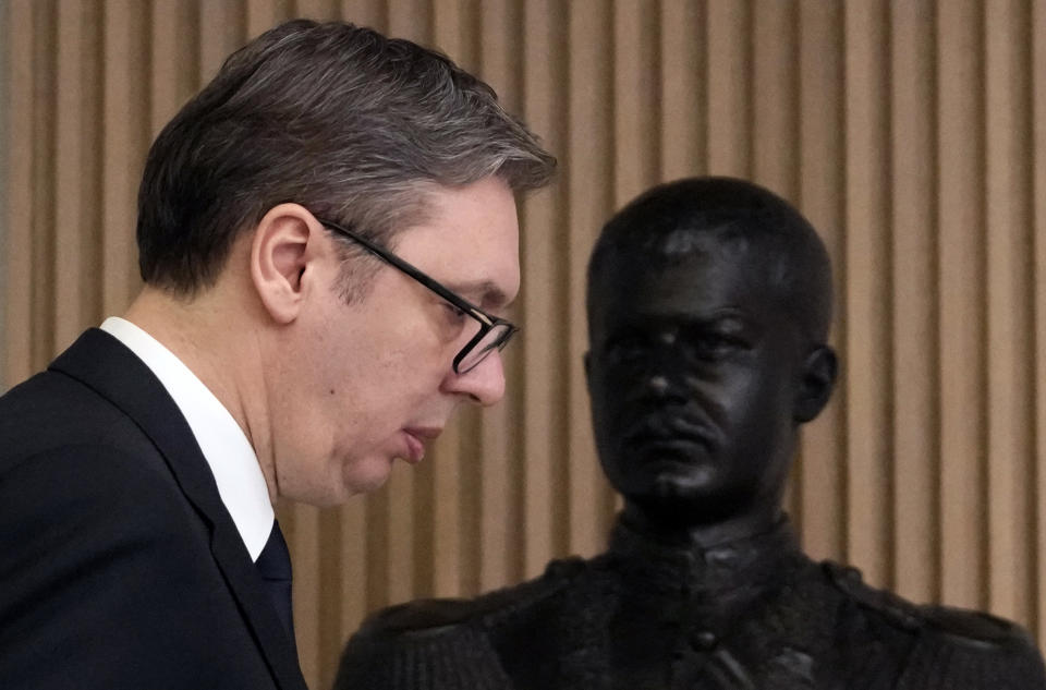 Serbian President Aleksandar Vucic walks by a bust of the former Serbian King Aleksandar Obrenovic as he arrives at a press conference after meeting with European Union envoy Miroslav Lajcak, in Belgrade, Serbia, Friday, Jan. 20, 2023. Western envoys on Friday were visiting Kosovo and Serbia as part of their ongoing efforts to defuse tensions and help secure a reconciliation agreement between the two. (AP Photo/Darko Vojinovic)