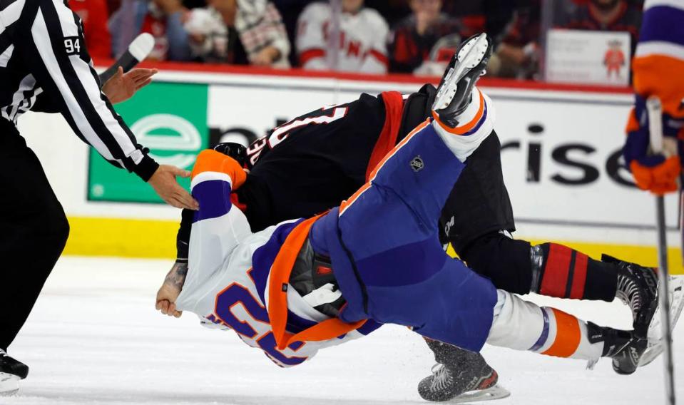 Carolina right wing Stefan Noesen (23) takes down New York center Kyle MacLean (32) as they fight during the first period of the Hurricanes game against the Islanders in the first round of the Stanley Cup playoffs at PNC Arena in Raleigh, N.C., Monday, April 22, 2024.