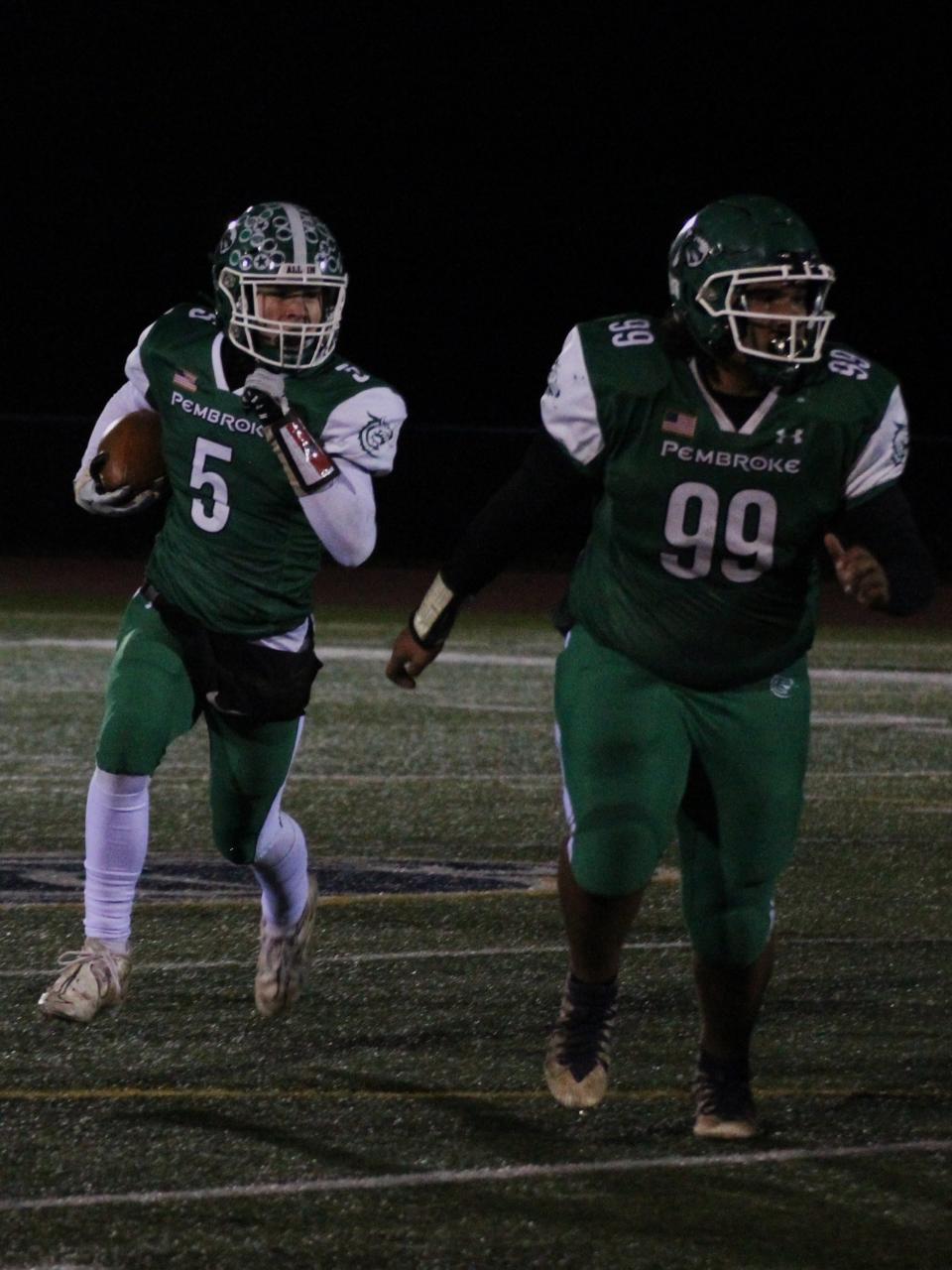 Pembroke junior Tyson Totten during one of his 40 carries during the 8-man regional state semifinal, this one with Octavious Martin leading the way.