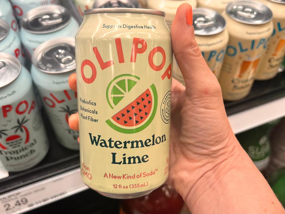 hand holding up a can of watermelon lime olipop at a target