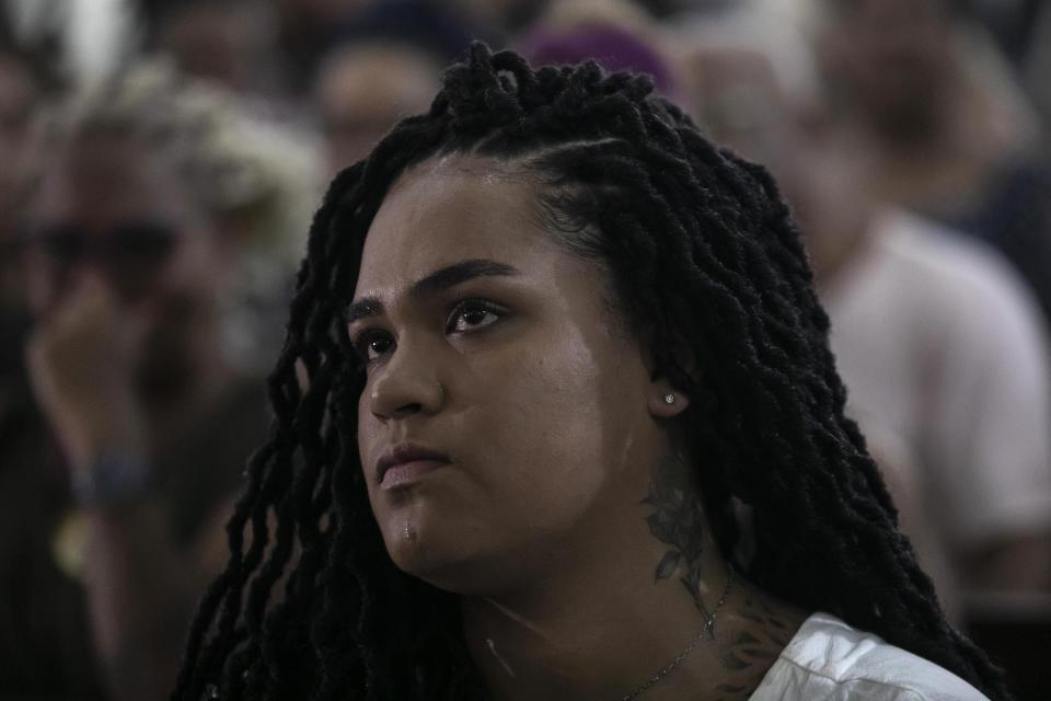 Luyara Santos, daughter of slain councilwoman Marielle Franco, cries during a Mass in honor of her mother and driver Anderson Gomes, marking five years of their murders, still under investigation, in Rio de Janeiro, Brazil, Tuesday, March 14, 2023. (AP Photo/Bruna Prado)