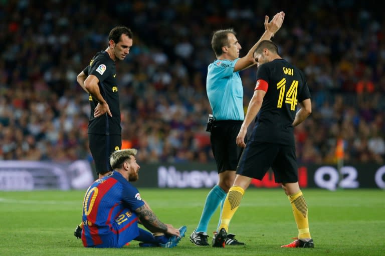 Barcelona's Lionel Messi sits on the ground before leaving the pitch during the match against Atletico de Madrid at the Camp Nou stadium in Barcelona on September 21, 2016