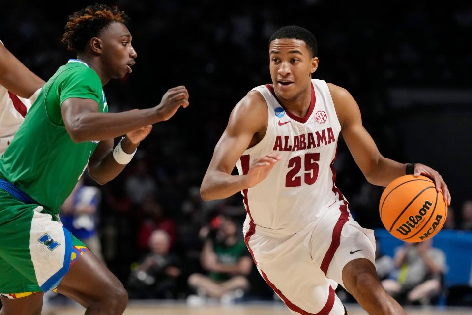 Alabama guard Nimari Burnett (25) turns the corner as he dribbles up court past Texas A&M-CC guard Jalen Jackson, left, in the second half of a first-round college basketball game in the NCAA Tournament in Birmingham, Ala., Thursday, March 16, 2023. Alabama won 96-75. (AP Photo/Rogelio V. Solis)