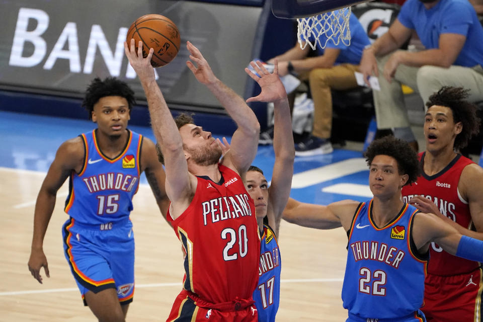 New Orleans Pelicans forward Nicolo Melli (20) shoots in front of Oklahoma City Thunder forward Josh Hall (15), forward Aleksej Pokusevski (17) and forward Isaiah Roby (22) during the second half of an NBA basketball game Thursday, Dec. 31, 2020, in Oklahoma City. (AP Photo/Sue Ogrocki)