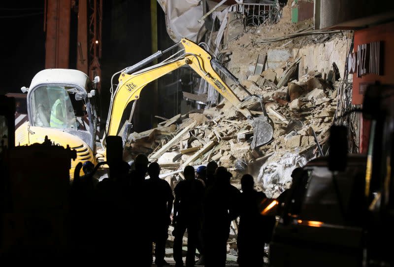 Machinery works at the site of buildings which collapsed by the explosion at the city's port area, in Gemmayze, Beirut