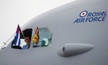 A pilot looks out of the cockpit as the plane carrying Britain's Prince Charles and Camilla, Duchess of Cornwall, arrives in Havana, Cuba, March 24, 2019. REUTERS/Phil Noble