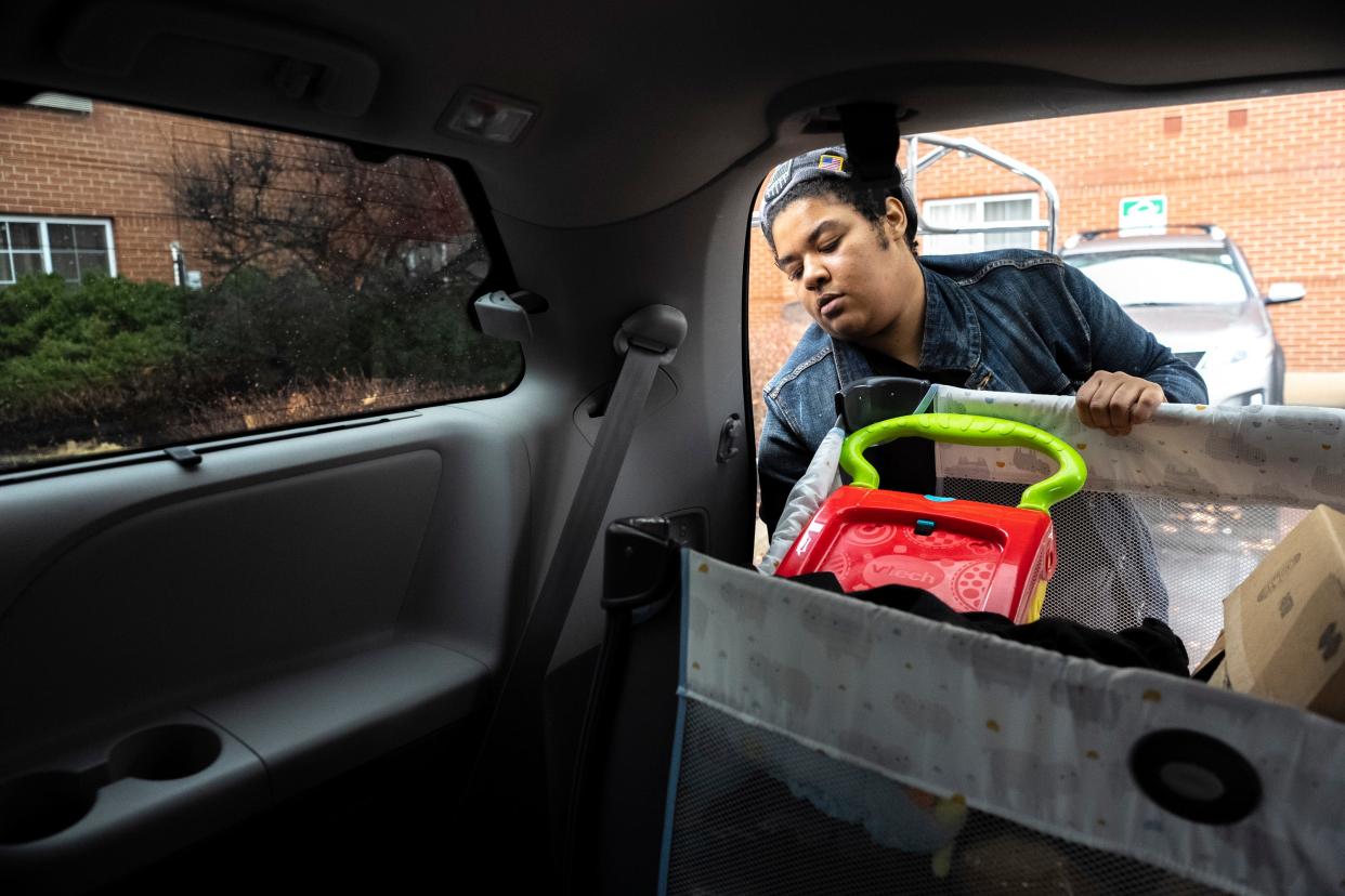 Daisha Harper, previously a resident of Latitude Five25, unpacks her belongings from an Uber she took while moving from one motel to another in January while continuing to live in temporary housing.