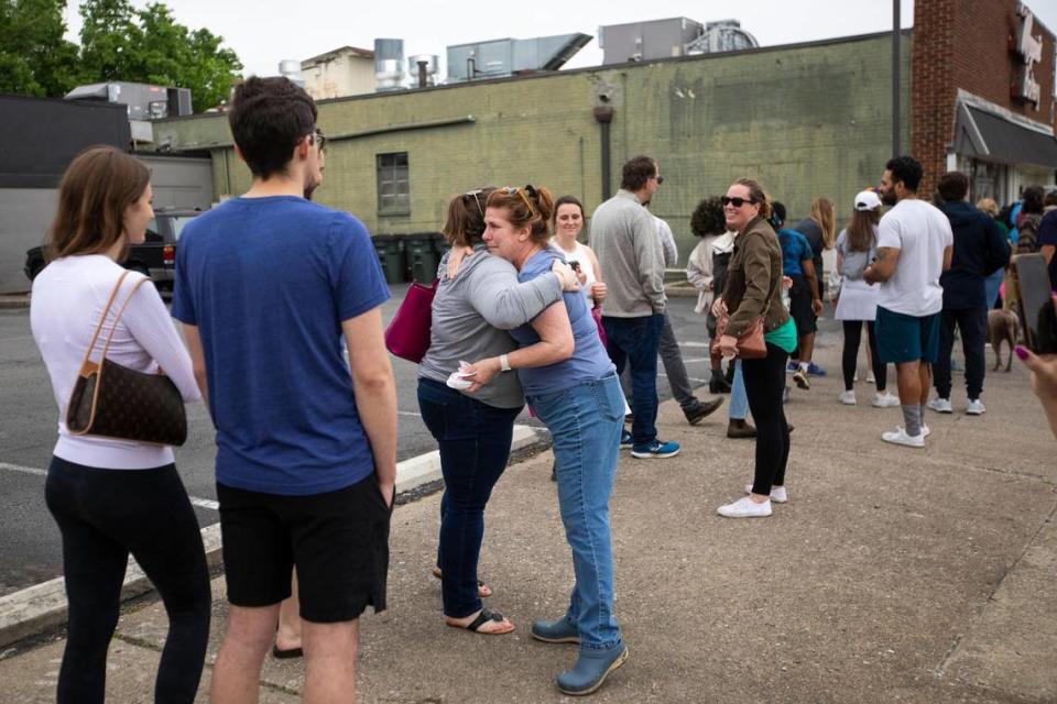 Co-owner Beverly Higgins hugs patrons that gathered around the corner of South Ashland and Main Street to try and purchase something on the last day of business for Magee’s Bakery in Lexington, Ky., Saturday, May 13, 2023. Some people waited in line over two hours.