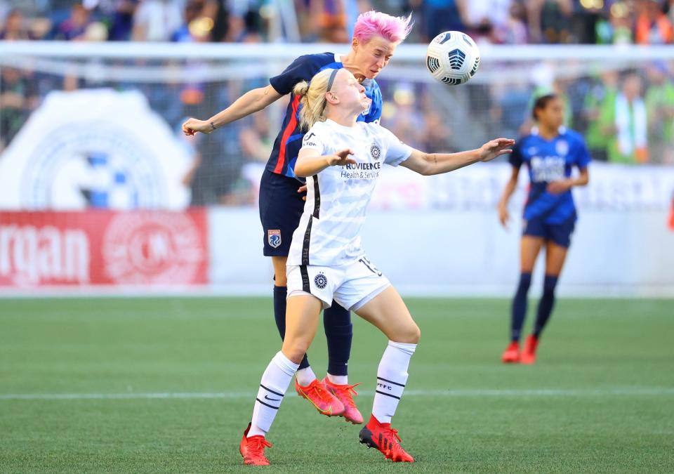 Megan Rapinoe and Madison Pogarch compete for a loose ball.