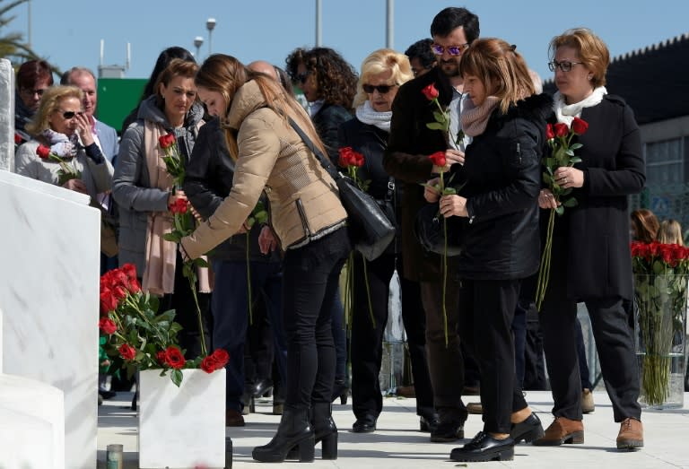 Relatives of the victims of the Germanwings crash display flowers in front of the commemorative plaque set for the victims of the Germanwings plane which crashed into the French Alps and claimed 150 lives, at Barcelona's airport, in El Prat de Llobregat on March 23, 2017