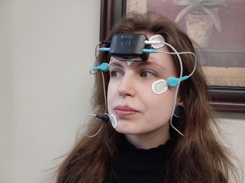 Masters student Emily White demonstrates how the Cerebra device is worn.