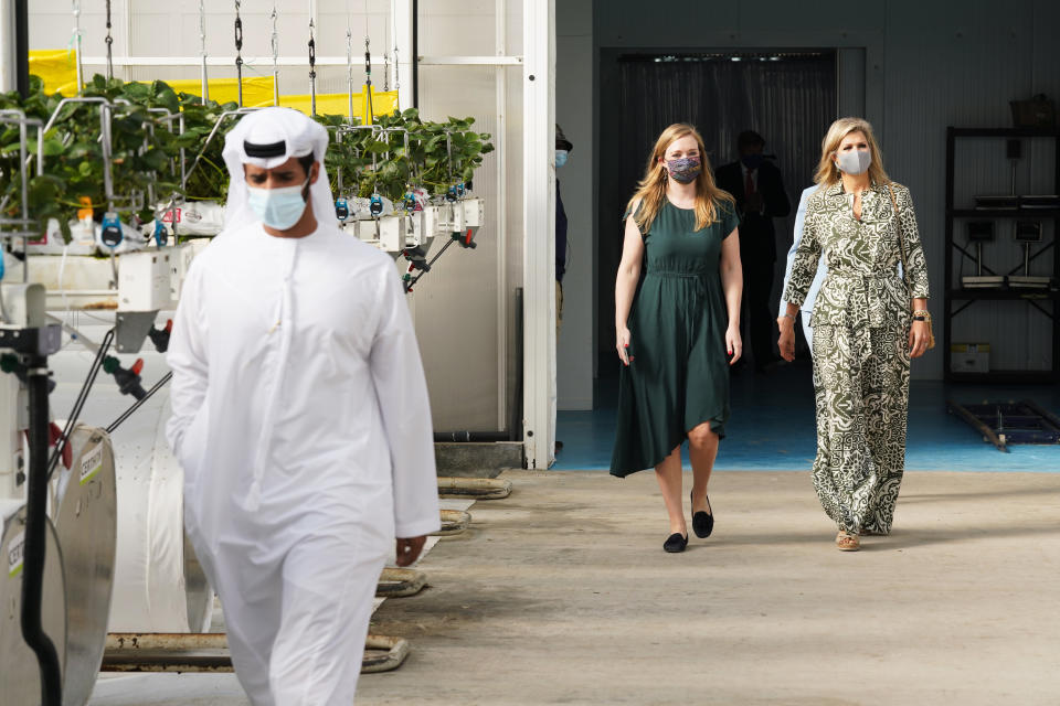Queen Maxima, right, visits the Pure Harvest strawberry farm near Sweihan in Abu Dhabi, United Arab Emirates, Wednesday, Nov. 3, 2021. King Willem-Alexander and Queen Maxima of the Netherlands are in the United Arab Emirates as part of a royal trip to the country to visit Dubai's Expo 2020. (AP Photo/Jon Gambrell)