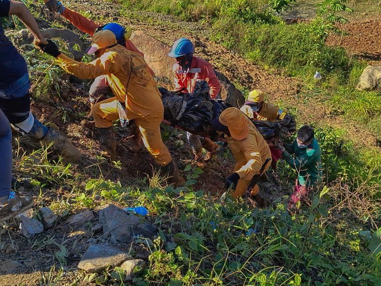 Rescatistas llevan un cuerpo recuperado entre los escombros