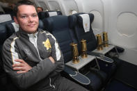 In this image made available by LOCOG, Inspector Andy Marriner from the Metropolitan police secures the Olympic Flame into seat 1a and 1b for the flight from Greece to Britain, Friday May 18, 2012. (AP Photo/Chris Radburn/LOCOG HO)