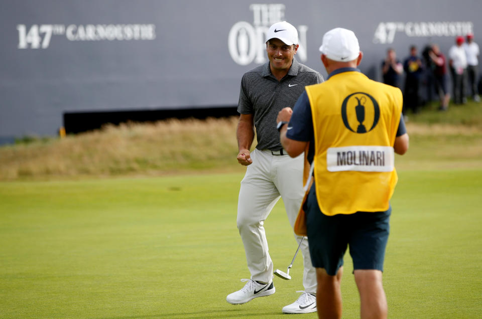 Italy’s Francesco Molinari reacts with his caddie after a birdie putt on the 18th during the final round of the British Open. (REUTERS)