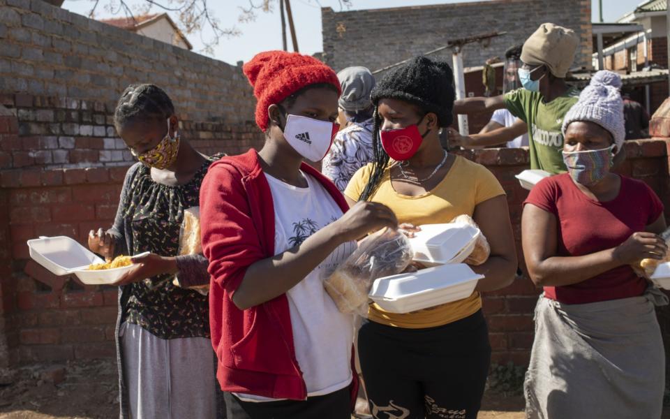 Women receive bread at a food handout during the Eid al Adha at the 'Hunger Has No Religion' feeding scheme, in Johannesburg - KIM LUDBROOK/EPA-EFE/Shutterstock/Shutterstock