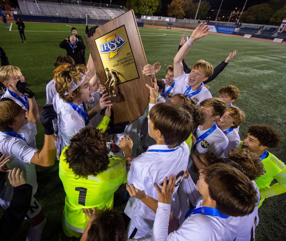 Noblesville High School players celebrate after winning an IHSAA class 3A boys’ soccer State Championship match against Carmel High School, Saturday, Oct. 30, 2021, at IUPUI’s Michael A. Carroll Track and Soccer Stadium in Indianapolis. Noblesville High School won 3-1.