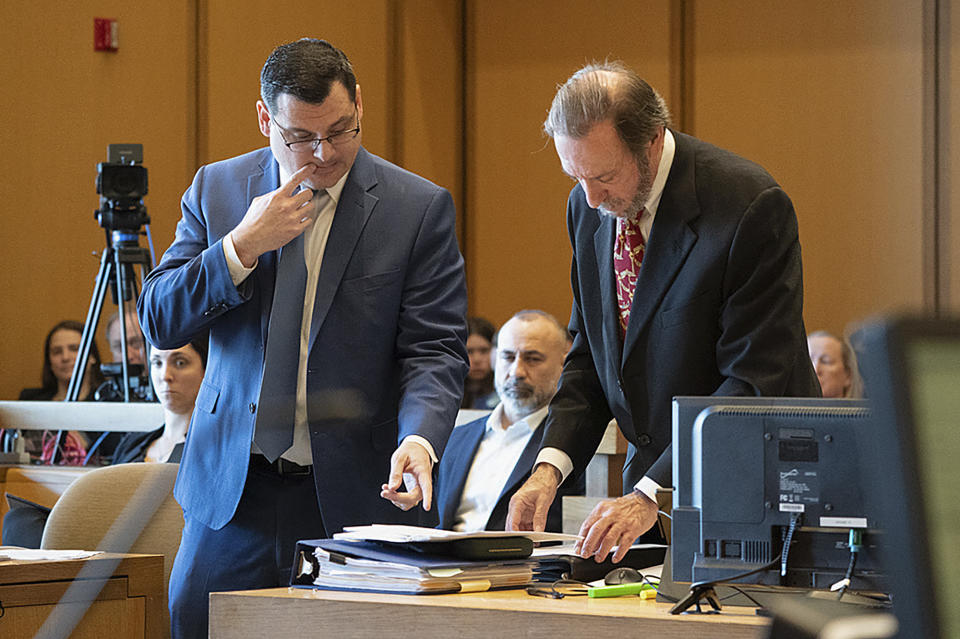 Sean McGuinness, attorney for the prosecution, left, and defense attorney Jon Schoenhorn, look over documents at the start of the murder trial of Michelle Troconis, Thursday, Jan. 11, 2024, in Stamford, Conn. The trial of Troconis, charged in the 2019 killing of mother-of-five Jennifer Dulos, has begun in Stamford Superior Court with a six-person jury hearing the case.(Richard Harbus/Dailly Mail via AP, Pool)