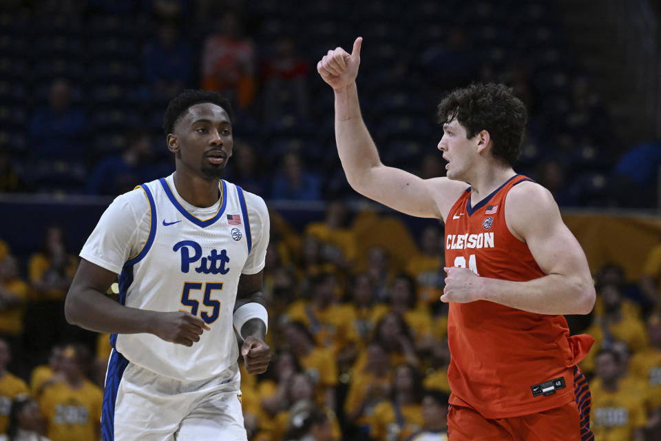 Clemson center PJ Hall, right, celebrates after a basket in front of Pittsburgh forward Zack Austin (55) during the second half of an NCAA college basketball game, Sunday, Dec. 3, 2023, in Pittsburgh. (AP Photo/Barry Reeger)