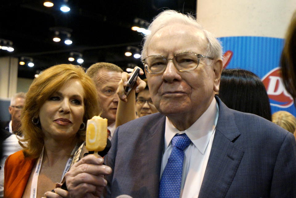 Berkshire Hathaway CEO Warren Buffett enjoys a Dairy Queen ice cream bar prior to the Berkshire annual meeting in Omaha, Nebraska May 2, 2015. Dairy Queen is a Berkshire Hathaway company.  REUTERS/Rick Wilking