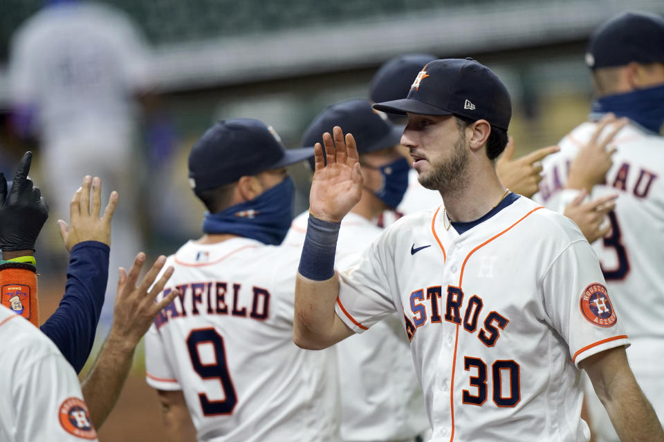 Houston Astros' Kyle Tucker (30) celebrates with teammates after a baseball game against the Texas Rangers Thursday, Sept. 17, 2020, in Houston. The Astros won 2-1. (AP Photo/David J. Phillip)