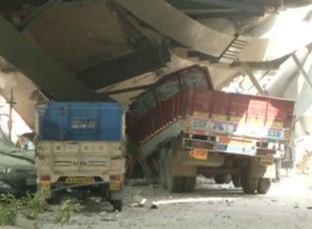 Vehicles are seen trapped under a flyover which collapsed in Kolkata