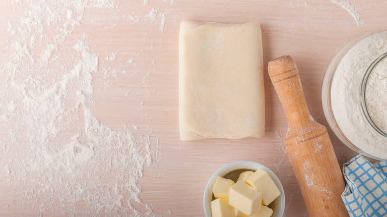 Puff pastry dough on kitchen surface