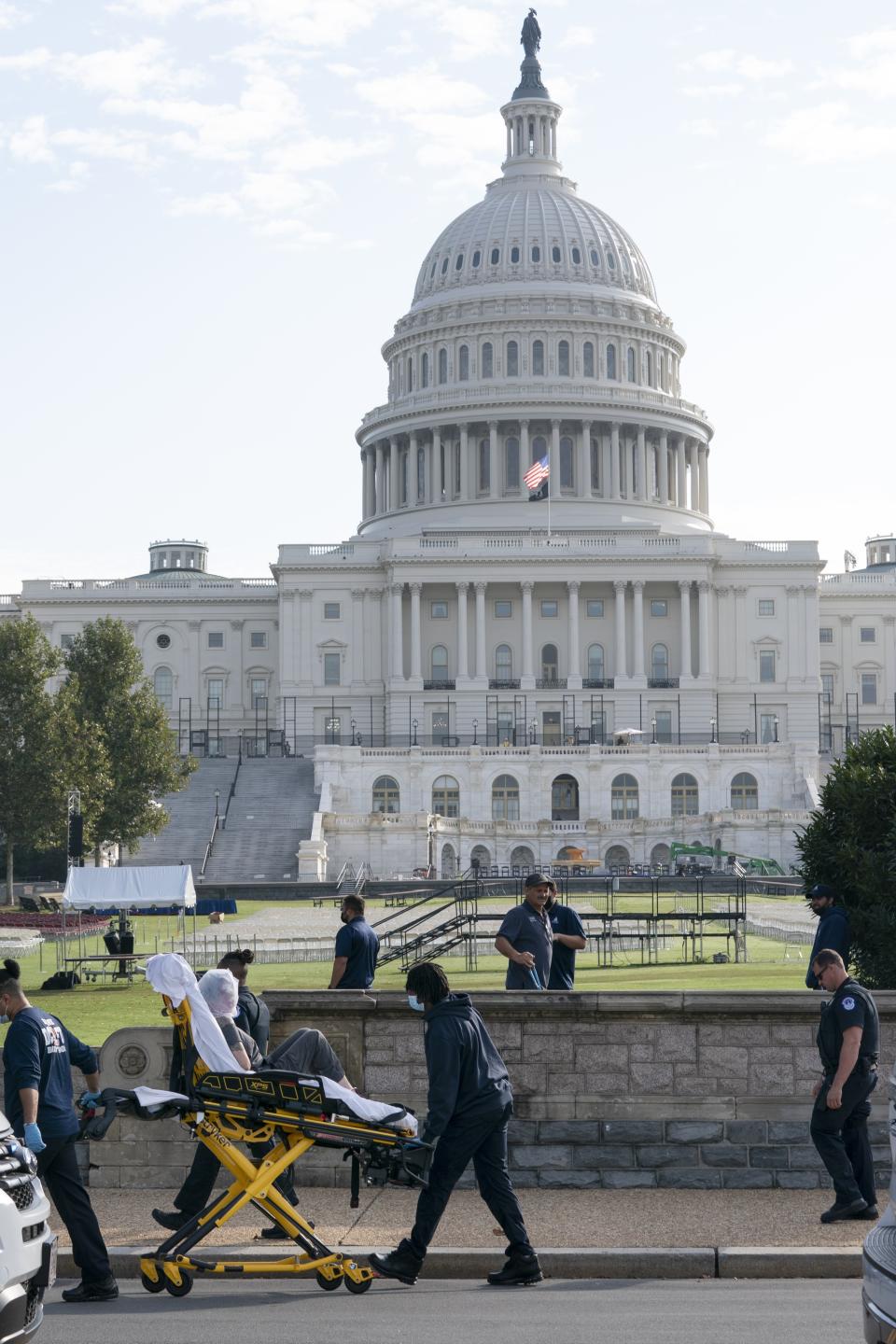 A woman yells through a bag that was placed on her head as she is removed via stretcher after reportedly wielding a bat at Capitol Police, Friday, Oct. 15, 2021, by the U.S. Capitol in Washington. (AP Photo/Jacquelyn Martin)