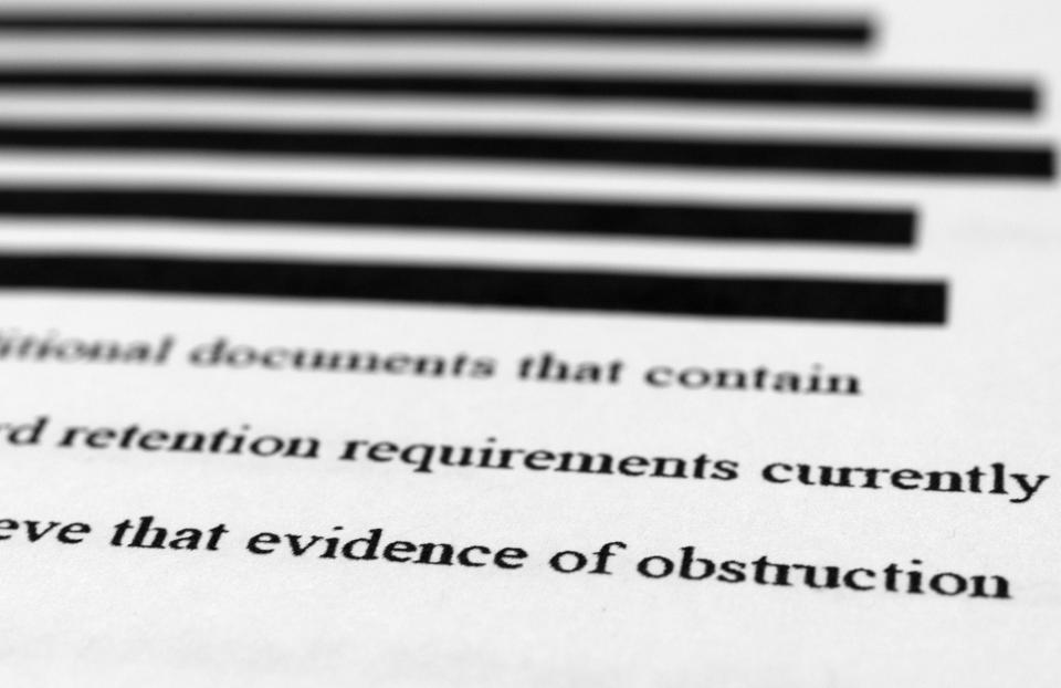 Pages from the affidavit by the FBI in support of obtaining a search warrant for former President Donald Trump's Mar-a-Lago estate are photographed Friday, Aug. 26, 2022. U.S. Magistrate Judge Bruce Reinhart ordered the Justice Department to make public a redacted version of the affidavit it relied on when federal agents searched Trump's estate to look for classified documents. (AP Photo/Jon Elswick)