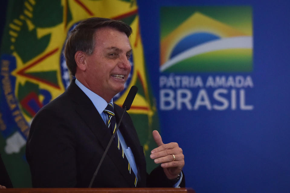 Jair Bolsonaro, Brazil's president, attends the inauguration of Fabio Faria, Brazil's communication minister, not pictured, at the Planalto Palace in Brasilia, Brazil, on Wednesday, June 17, 2020. BolsonaroÂ took another step to strengthen his allied base in Congress byÂ recreatingÂ the Communications Ministry and nominating DeputyÂ FabioÂ Faria, from the PSD party, as minister.Â Photographer: Andre Borges/Bloomberg