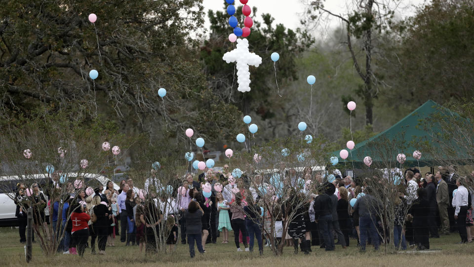 Balloons are released at a graveside service last week for members of the Holcombe family who were killed in the Sutherland Springs Baptist Church shooting. (Photo: Eric Gay/AP)