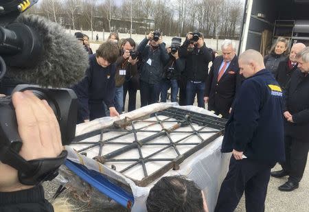 Media films and photographs a wrapped iron gate from Dachau concentration camp with the notorious "Arbeit macht frei" ("Work sets you free") which was returned to Dachau, Germany, February 22, 2017, after it was stolen in 2014. REUTERS/Ralph Brock