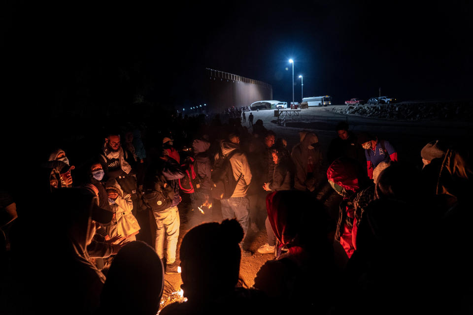 Migrants and asylum seekers are detained by U.S. Border Patrol agents after crossing the U.S.-Mexico border in Yuma County, near the Cocopah Indian Tribe's reservation on Dec. 8, 2022. Border Patrol agents estimated the group to be about 700 people.