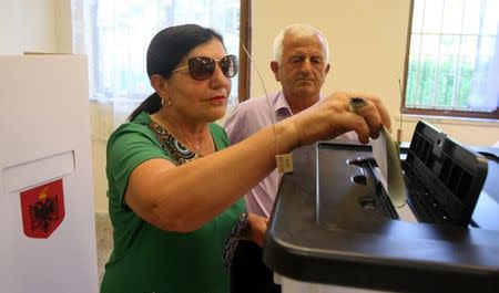 A woman casts her vote during the parliamentary election in Surel near Tirana, Albania June 25, 2017. REUTERS/Florion Goga