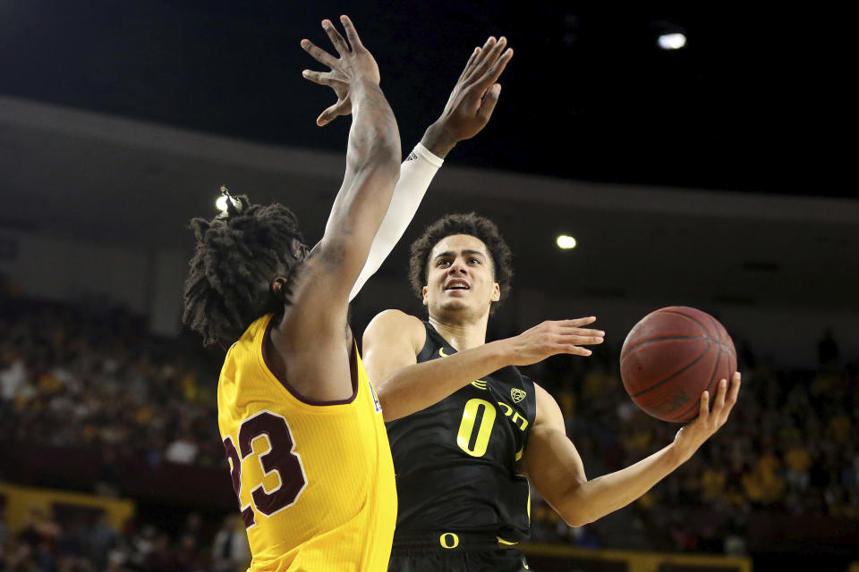 Oregon's Will Richardson (0) drive to the basket against Arizona State's Romello White (23) during the first half of an NCAA college basketball game Thursday, Feb. 20, 2020, in Tempe, Ariz. (AP Photo/Darryl Webb)