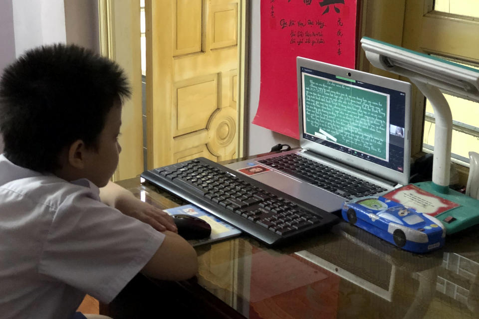 Fourth grader Han Binh Cuong attends a lesson via virtual classroom in Hanoi, Vietnam Monday, Sept. 6, 2021. Over 20 million Vietnamese students start a new school year on Monday, many of them on virtual classrooms as more than half of the country is in lockdown to contain a COVID-19 surge. (AP Photo/Binh Huy)