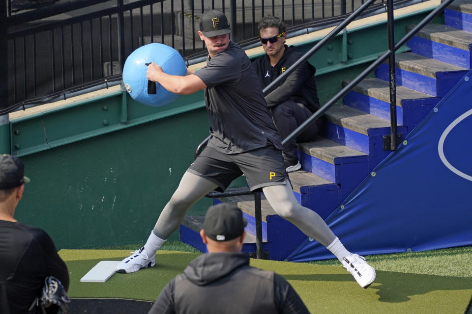 Pittsburgh Pirates first round draft pick, pitcher Paul Skenes works out as pitching coach Oscar Marin, bottom center, watches, in the bullpen after meeting with reporters after signing with the team in Pittsburgh, Tuesday, July 18, 2023. The Pirates drafted Skenes first player overall in this year's Major League Baseball draft. (AP Photo/Gene J. Puskar)